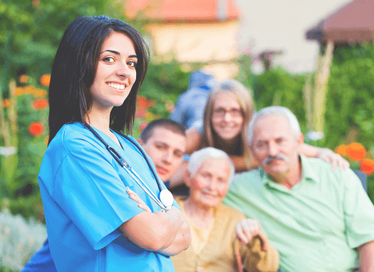 smiling caregiver with a family on the back