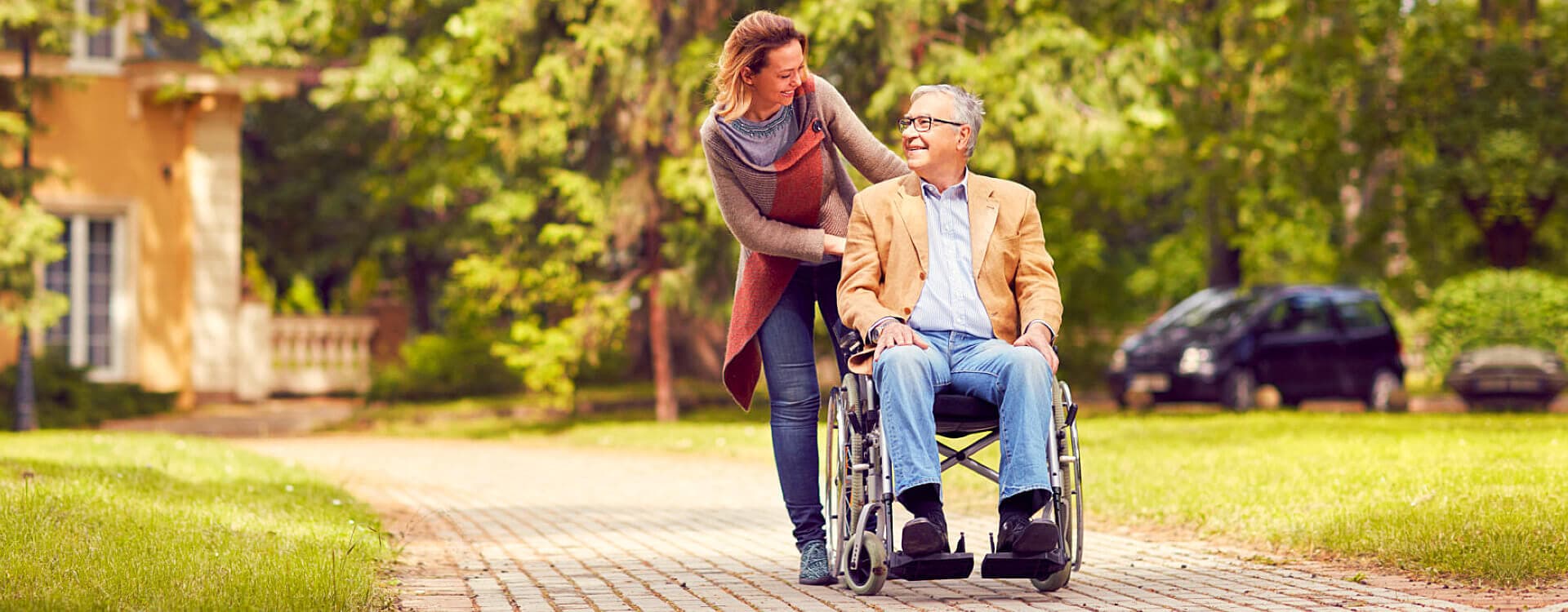 caregiver and patient in a wheelchair looking at each other