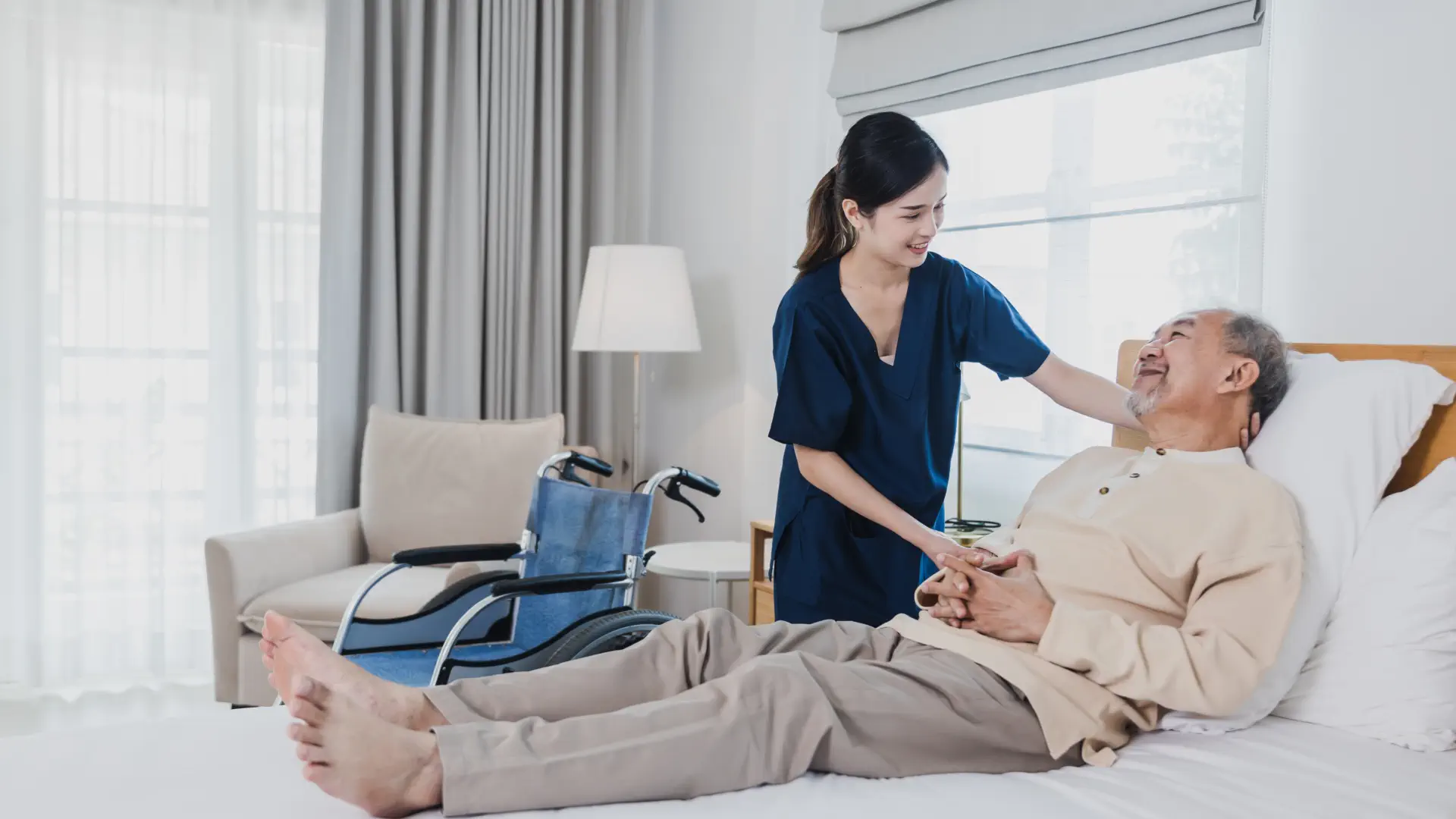 caregiver and an elderly talking in the living room