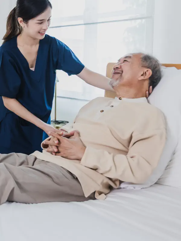 caregiver and an elderly talking in the living room