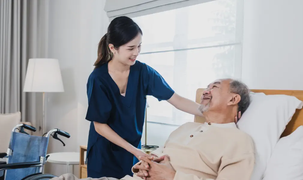 caregiver and an elderly talking in the living room