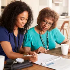 Nurse and patient reviewing paperwork