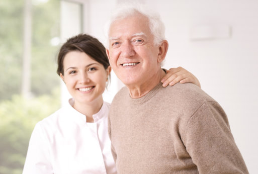 caring nurse and elderly smiling