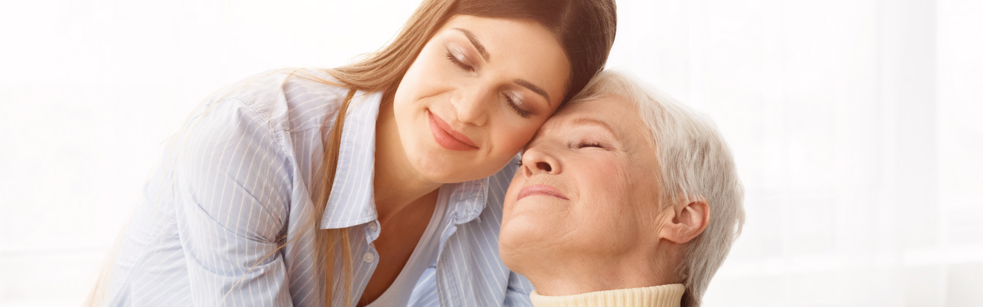 caregiver and an elderly hugging